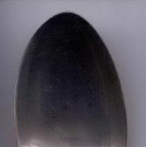 Silver serving spoon with "VEBP" engraved in handle