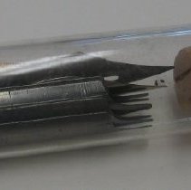 Glass bottle with metal pen tips