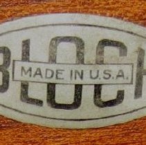 Close up of plate on wheelchair with cane back and leg supports