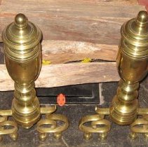Brass andirons with removable feet and trophy shaped top