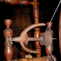 Close up of treadle spinning wheel for flax