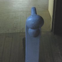 Andiron with a flat bar front and ending in an iron ball