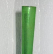 Green glass bud vase with bulbous base and long slender tapering stem