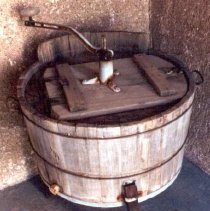 Round wash tub on three legs, with lid and hand crank on top