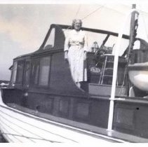 Woman standing on the deck of a boat