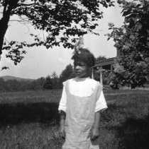 Negative of an African American girl on the lawn at Pennypacker Mills