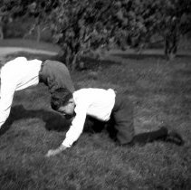Negative of Samuel W. Pennypacker II and a boy playing football