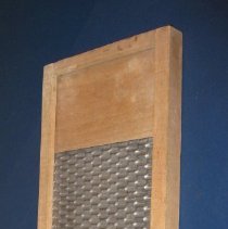 Washboard with metal grate on one side and three back boards on the other