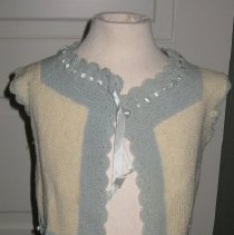Young child's cotton vest with light blue trim around all edges