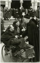 Priest Greeting Man in Pull Cart, Lourdes, 1958