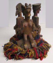 Headpiece surmounted by three standing figures