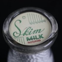 Paper cap on top of glass cream bottle