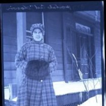 Woman in front of house