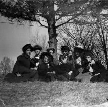 Group of Women in Hats Sitting on the Ground
