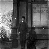Outdoor Informal portrait of boy standing with dog
