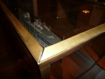 Close-up of metal lip being bent for glass removal