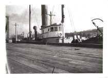 Steam tug Wallowa taking a barge out of the Ballard Locks, circa 1914