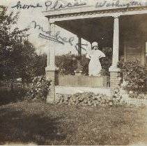 Mabel Baldwin standing on a porch (ca. 1929)