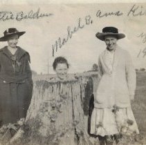 Mabel Baldwin in a hollow tree stump with Nettie Baldwin & Anna Kise (1919)