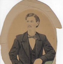 Photograph of man & boy in front of barn  (ca. 1890-1910)