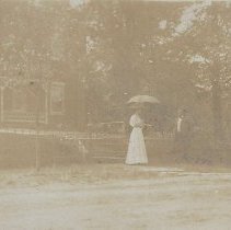 Woman & man in front of Harned Home in Washington (ca. 1880-1900)