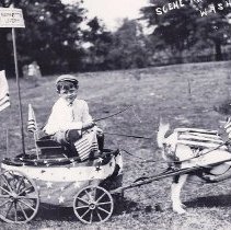 Young boy in a parade promoting Barnett's Livery in Washington (ca. 1905-19