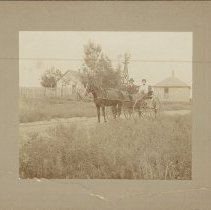 Frederick G. and Margaret Riethmann in Wagon on Farm