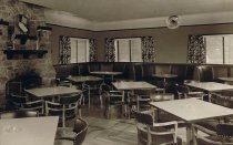 Dining area with booths and 4 tops, fireplace