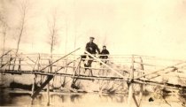 Man and boy on bridge sitting on rails