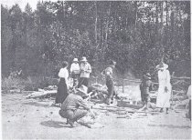 Preparing the picnic lunch on the sandy shore of a lake