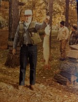 Guest holding a musky  ca late 1970s