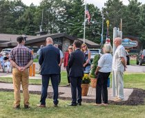 MWHS President Frank DiLeonardi standing beside monument