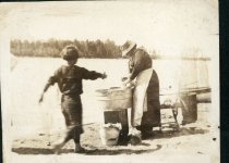 Rinsing sheets in the lake on laundry day