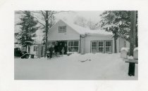 Early 1940s Cal LaPorte standing behind dog