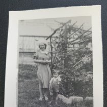 unknown Woman and Child standing in arbor in front of Selhorst florist gree