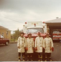 4 young men standing in front of fire truck