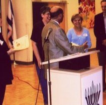 Men and women smiling at event at Jewish Federation building