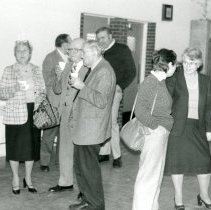 People standing in community room at Temple Beth-El