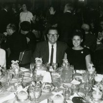 Man and woman posing at elegant dinner table