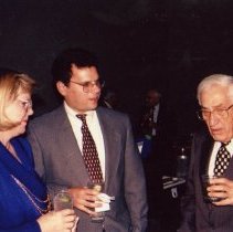 Three adults in conversation