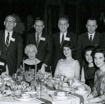 People posing at elevant dinner event