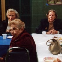 Women sitting at tables and listening