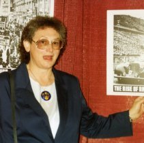 Woman standing in front Holocaust posters