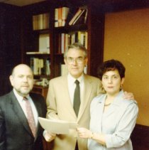 Three people posing for photograph