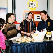 Four people enjoying refreshments