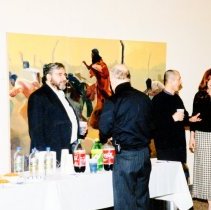 People standing near beverage table