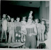 Children on stage with adult in costume in front of them