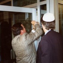 Mezuzah being placed on Federation building at dedication