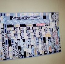 Blue quiilt hung on wall