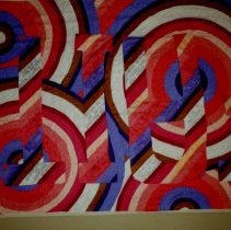 Red swirl quilt mounted on wall